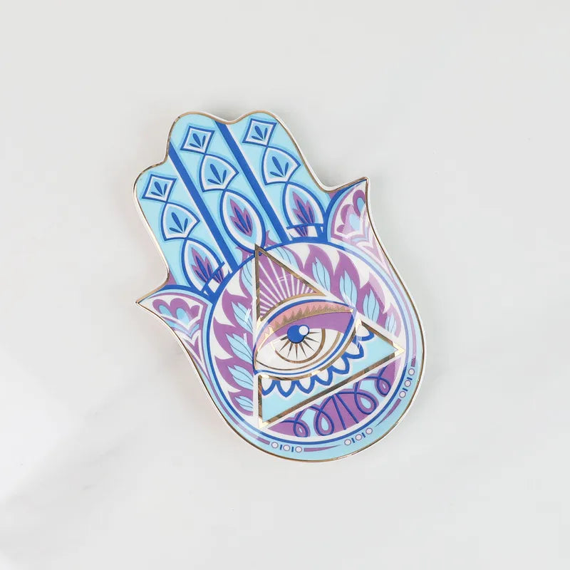 Decorative Hamsa plate with eye design on a white background